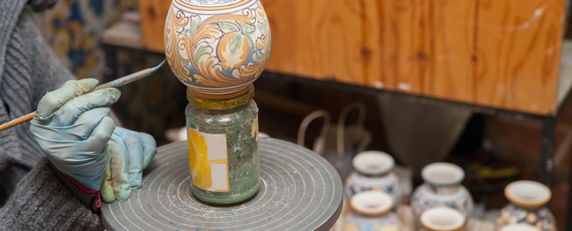 View of a ceramic small pot from Caltagirone being decorated by a local artisan